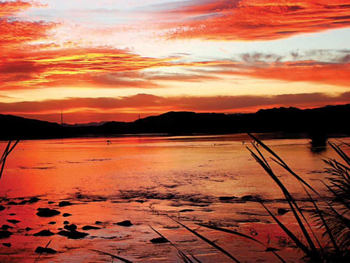 A photo of a sunrise at the Las Vegas Wash graces the cover of the 2022-2023 biennial report