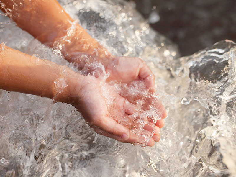 hands in rushing water