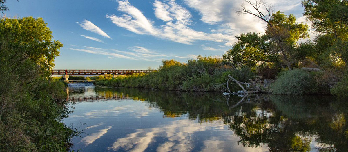 Upper division bridge showing blue sky reflected in water